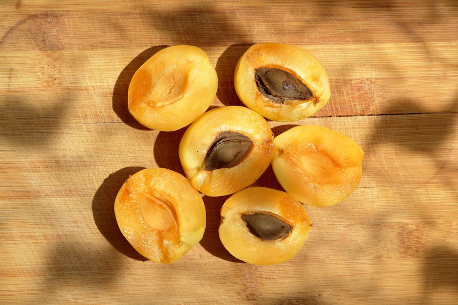 Abricots mûrs posés sur une table en bois clair